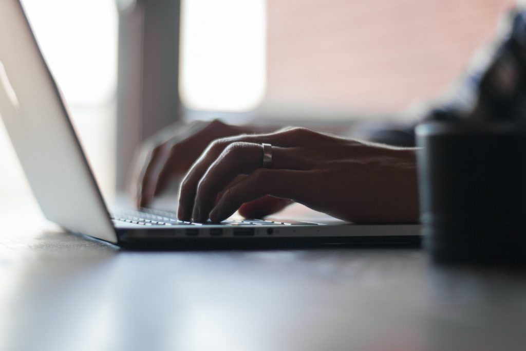 person typing on computer